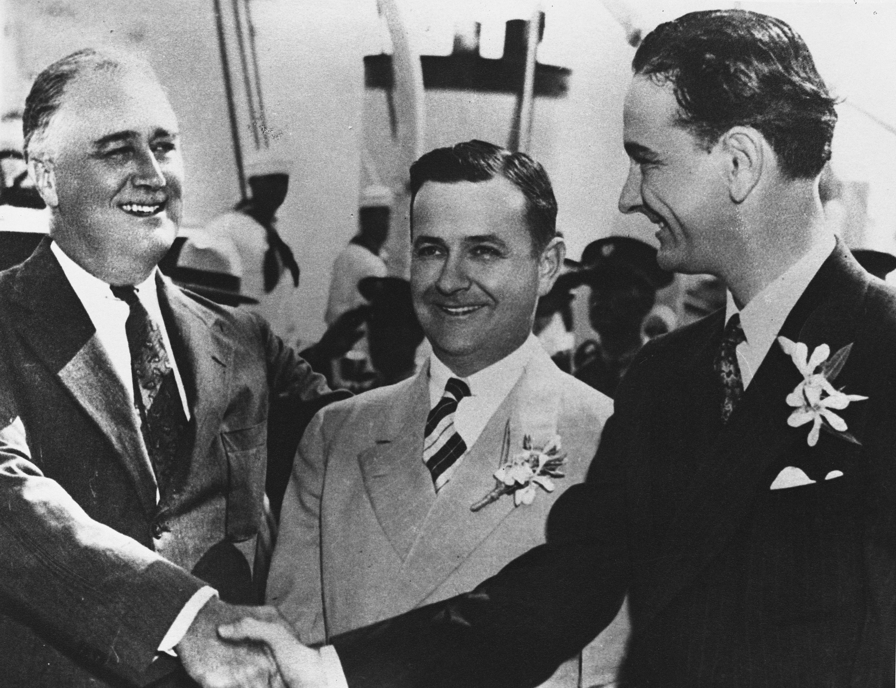 President Franklin Delano Roosevelt shakes Congressman Lyndon B. Johnson's hand, while Governor Allred stands behind them.
